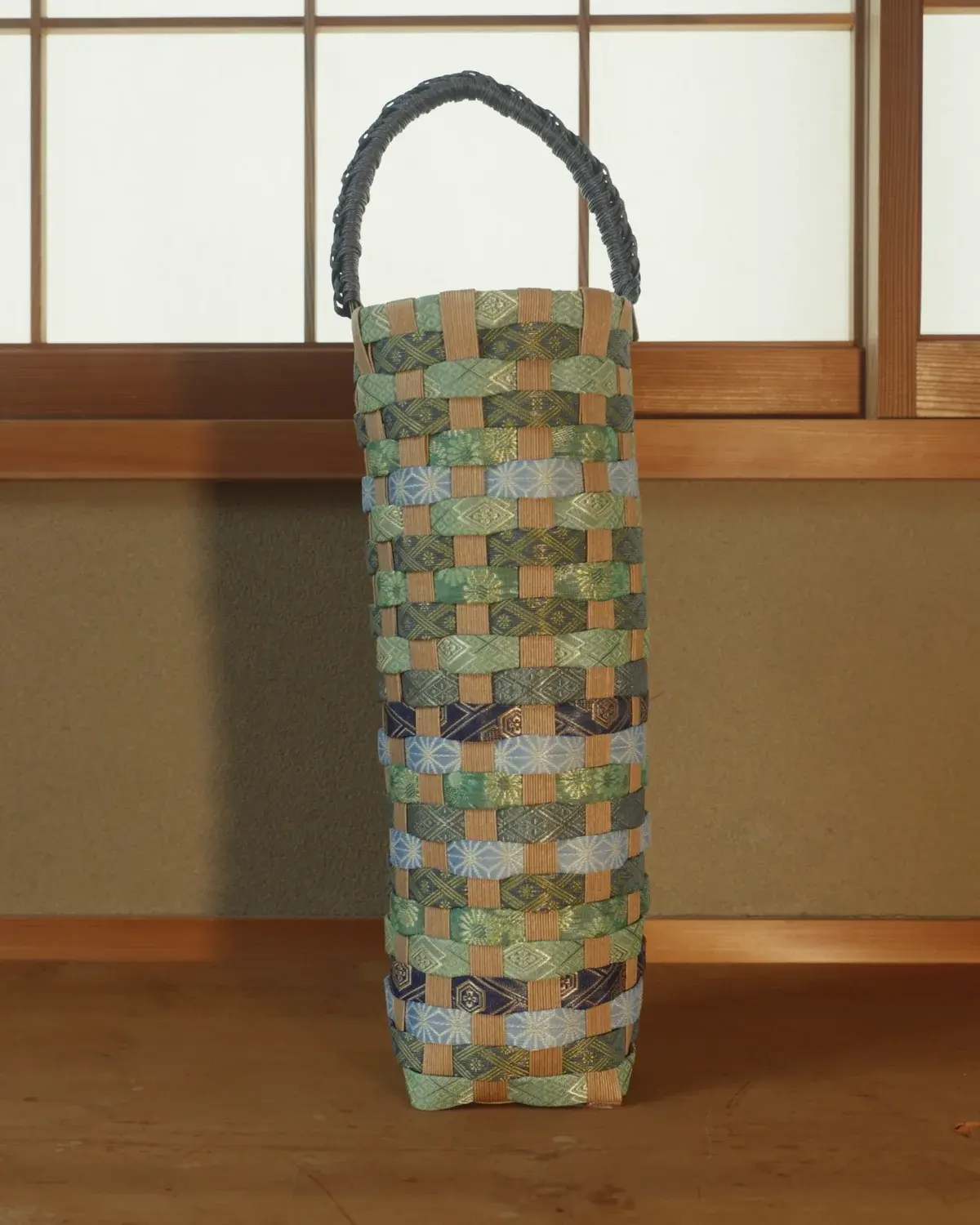 Ai — Moss, sky-blue and indigo bands beneath a hand-braided navy handle.