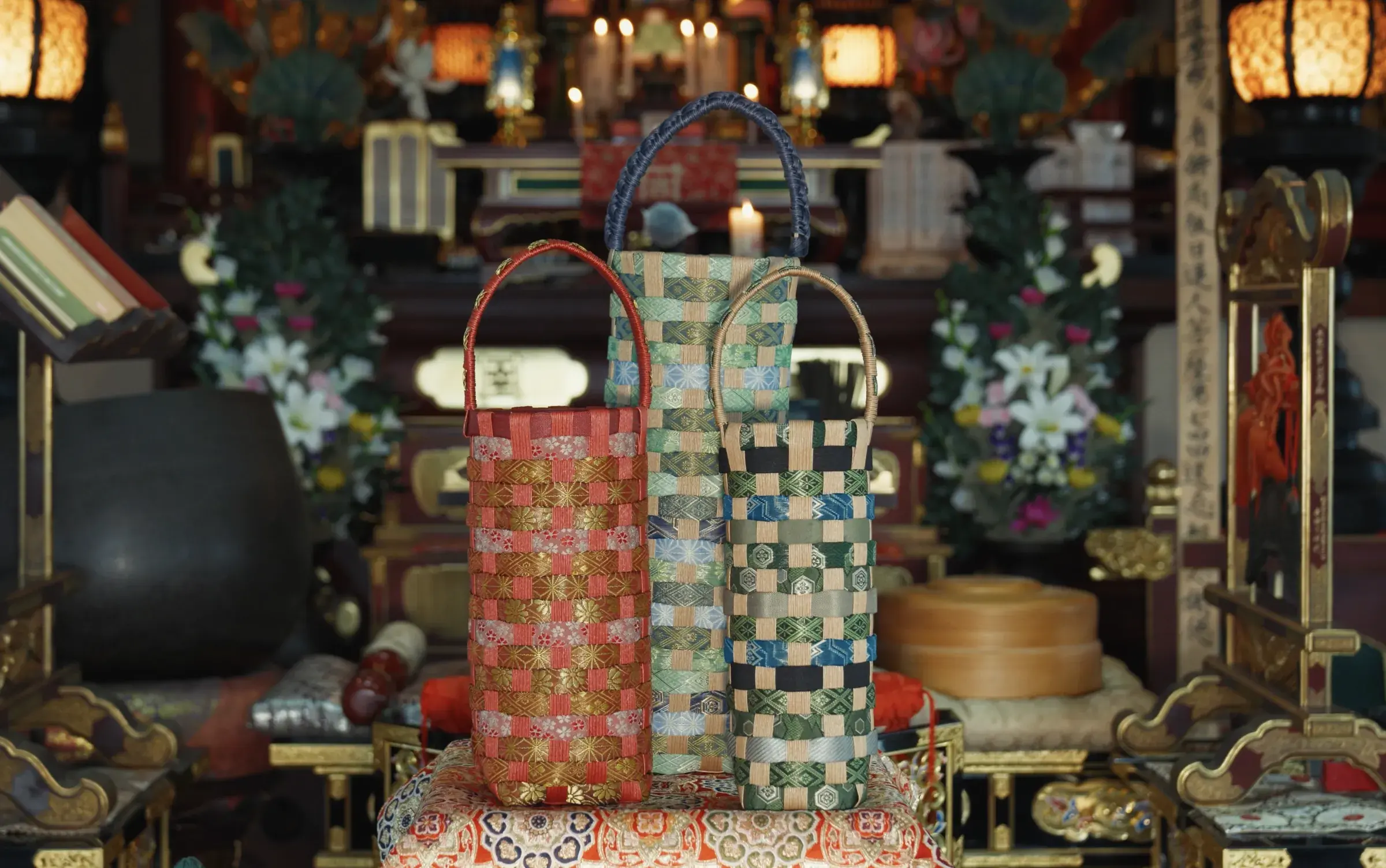 Three tatami-beri bottle bags standing on brocade before the altar of the main hall